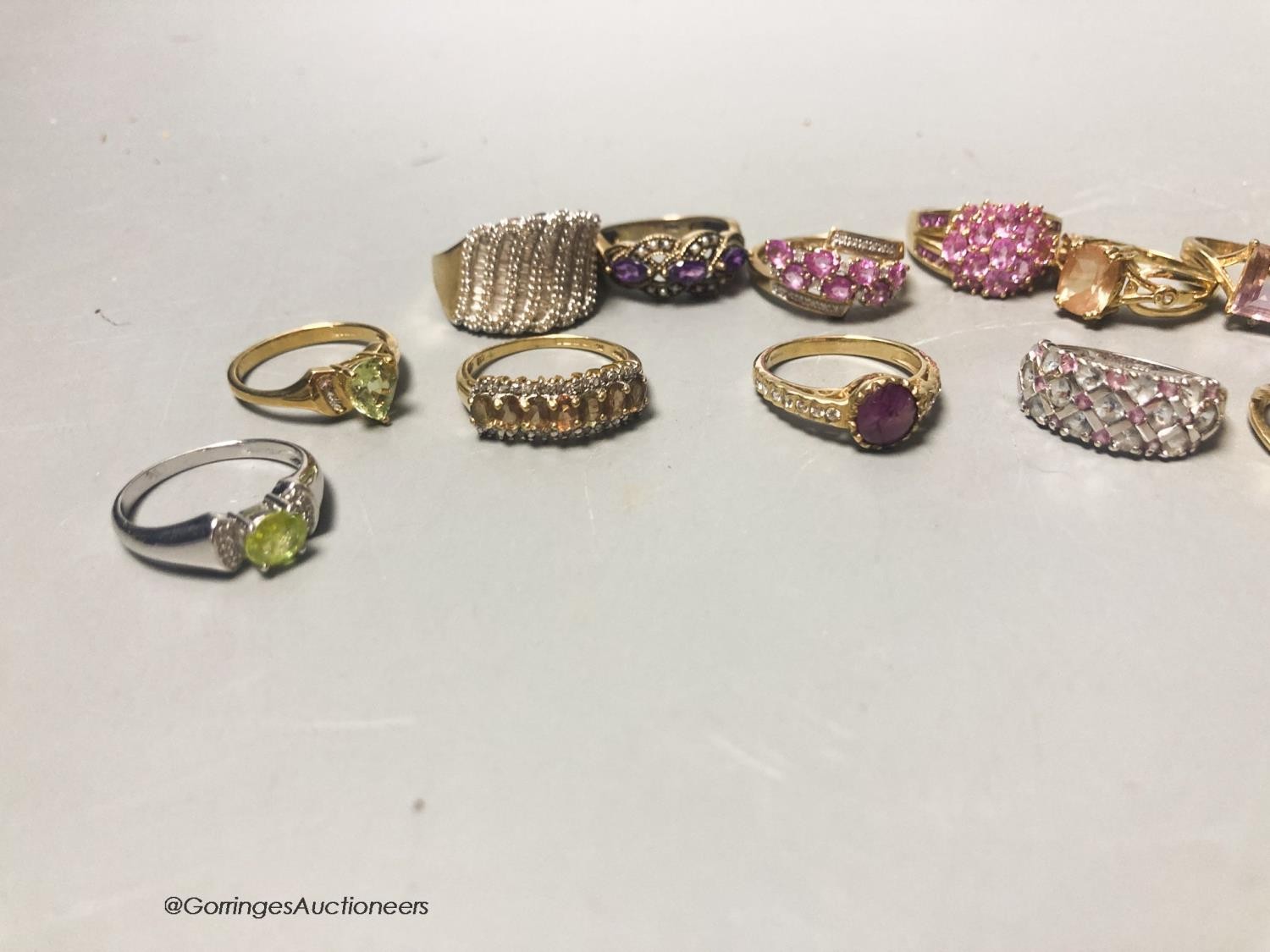 Twenty assorted modern 9ct or 9k and gem set dress rings, gross 66.4 grams.